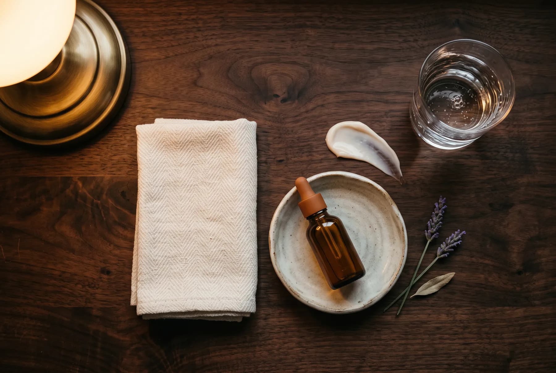 Evening skincare ritual arranged with a washcloth and moisturizer texture