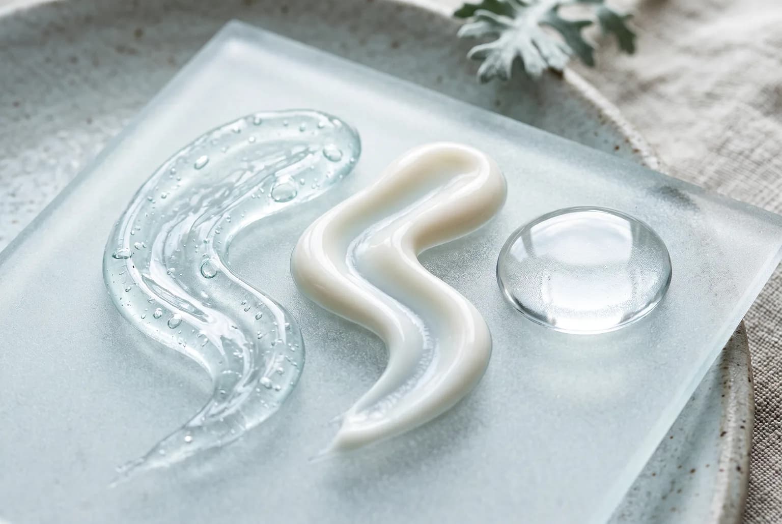 Abstract close-up of gel, cream, and serum textures for a layered skincare routine