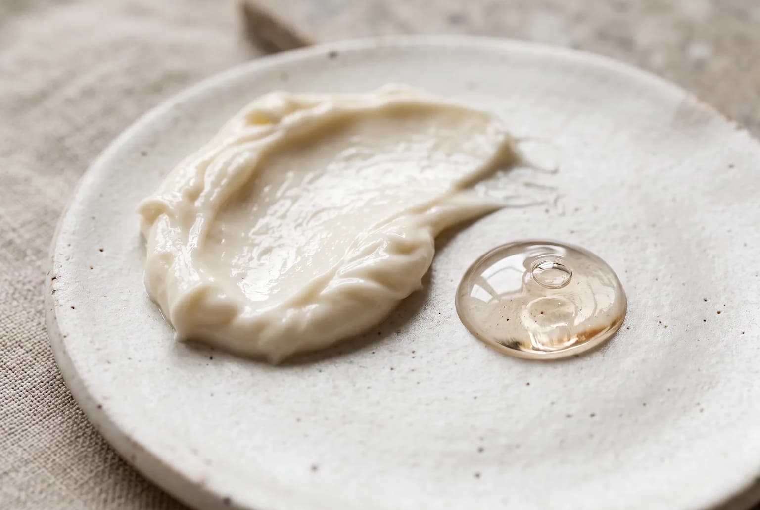 Cream texture on ceramic palette with clear serum drop