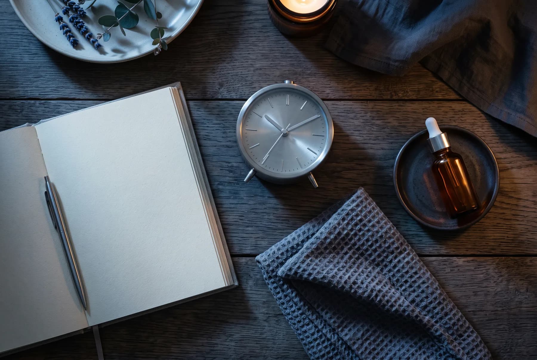 Nighttime skincare setting with an unbranded dropper and a minimalist routine journal