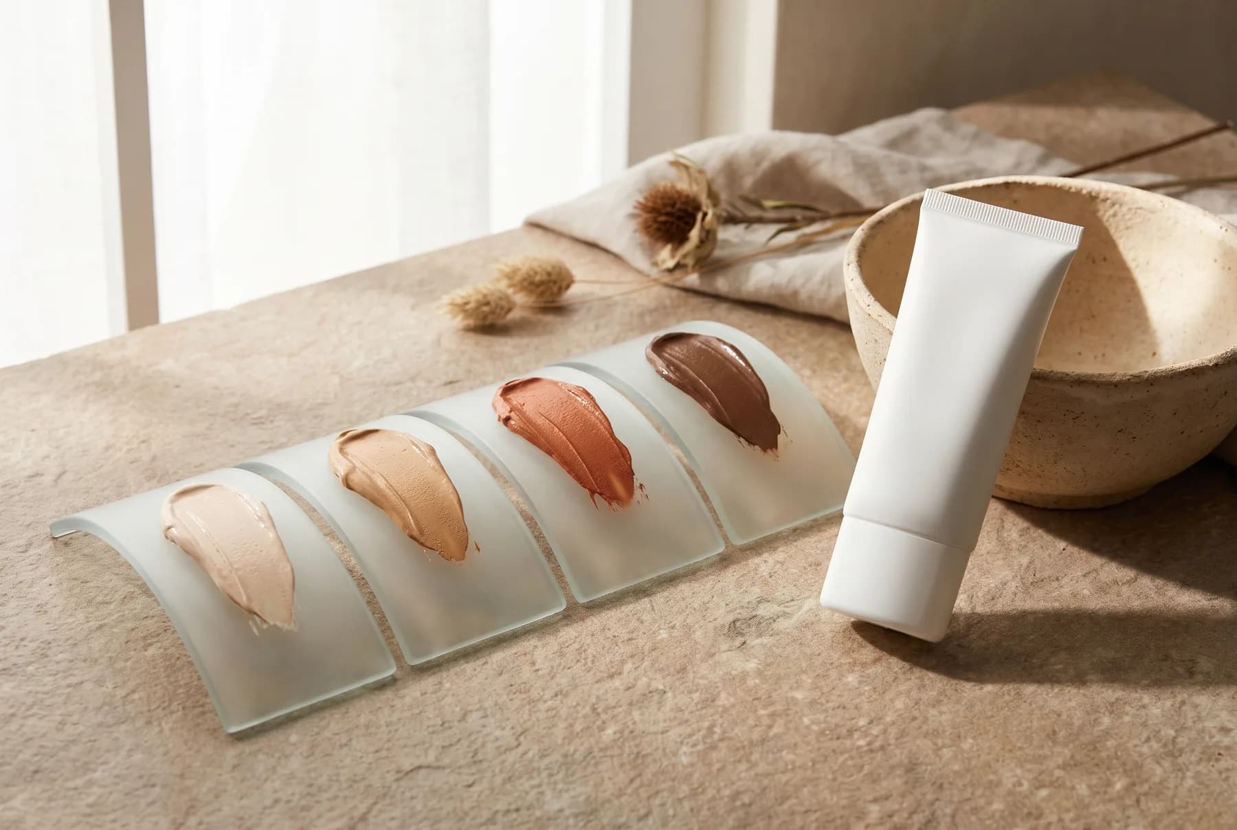 Tinted sunscreen shades arranged from light beige to deep umber