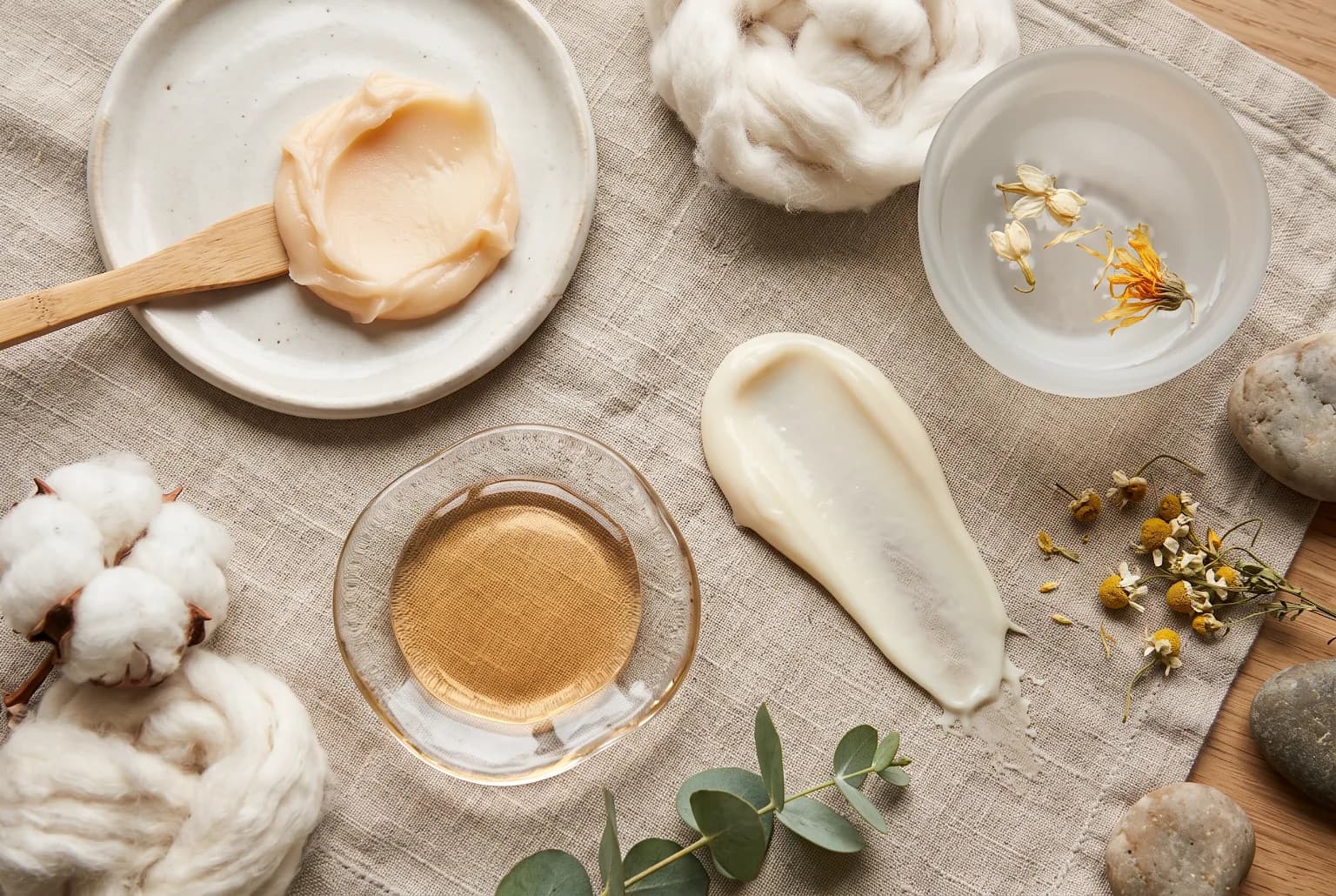 Cleansing balm, cleansing oil, and cream cleanser textures arranged on a neutral surface