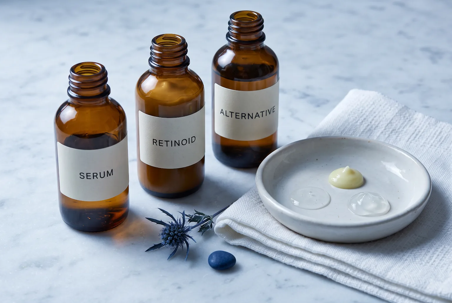 Three amber bottles with sample amounts of serum and treatment on a ceramic dish