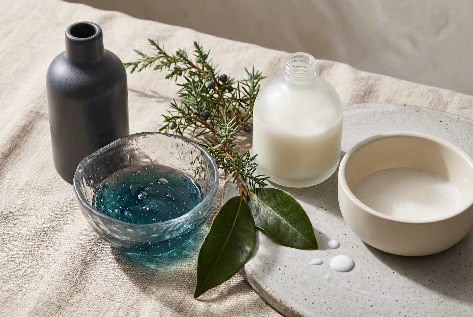 Glass vials and ingredient labels representing BHA, niacinamide and benzoyl peroxide